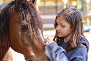 girl enjoying her equine therapy program 